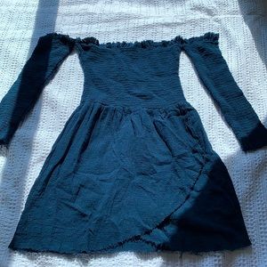 Off the shoulder with connecting sleeves.